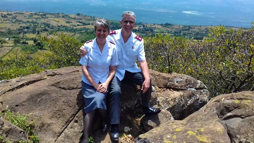 The Vincents, who are both from Newfoundland, sit on a rock with the Rift Valley in the background. The Salvation Army officers live in a gated compound in western Kenya with 15 other families. Security is essential for leaders in the country. There is a guard posted at the gate 24/7. CONTRIBUTED