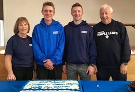 Marcus Hiscock (far right) and his wife Pats (far left) with grandsons Cameron (second from left) and Matthew cutting the cake during the 22nd Flame of Hope Walk for Diabetes Research in Buchans.