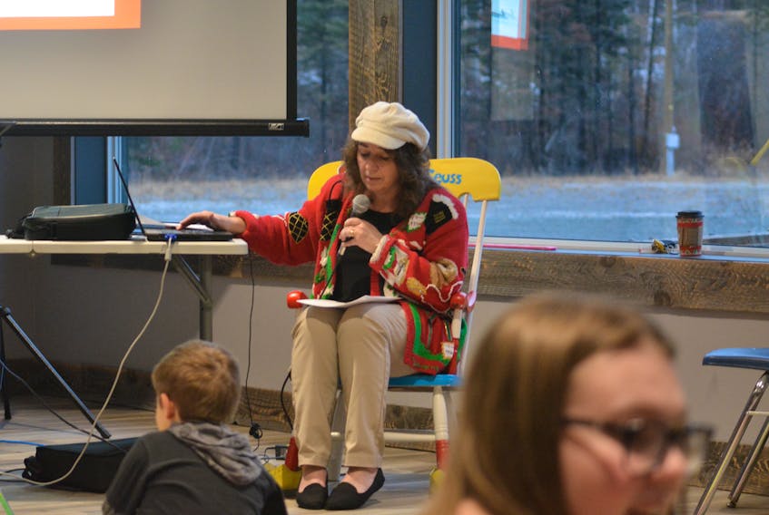 Grand Falls-Windsor's Holly Dwyer reads her Christmas poem during a Milk and Bookies event at the Exploits Nordic Ski Club on Dec. 15.