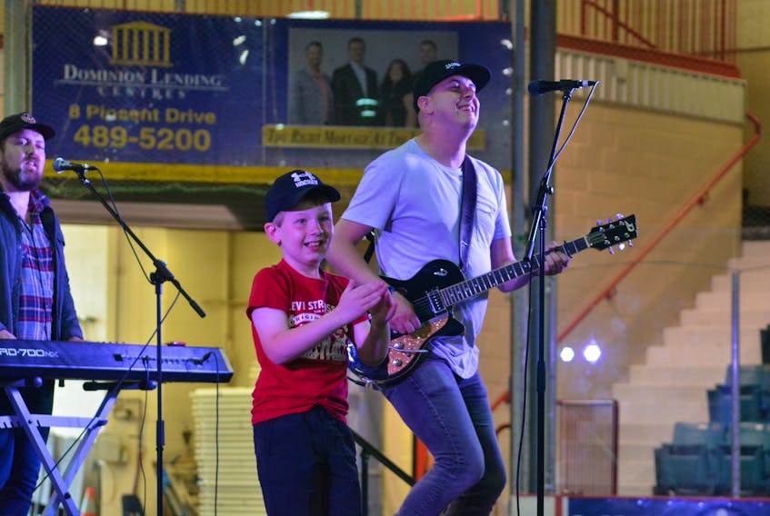 Nine-year-old Caleb Blackmore groves to the music of Carolina East moments after jumping on stage with the band during the Family Fun Day held at the Joe Byrne Memorial Stadium in Grand Falls-Windsor as a part of the 2019 Exploits Valley Salmon Festival.