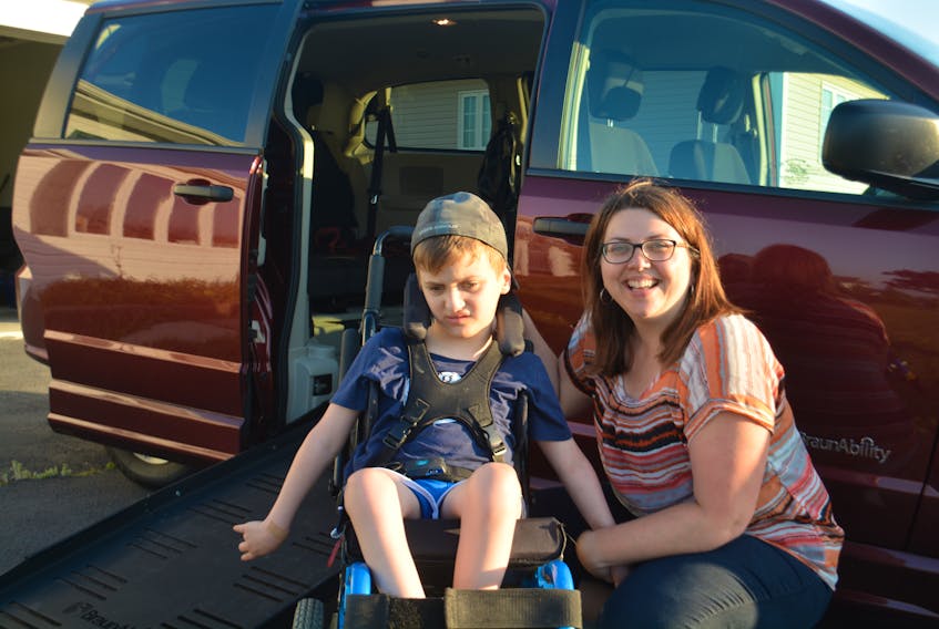 Erica Billings and her son Joel Stride pose for a photo in the family's new accessible van.