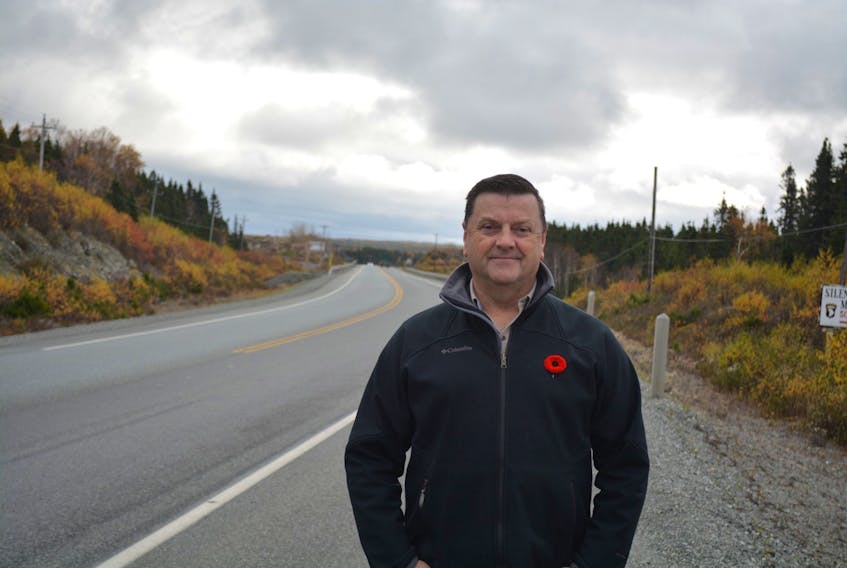 Gander Mayor Percy Farwell stands alongside the stretch of highway just outside Gander that the town is proposing to rename Remembrance Way.