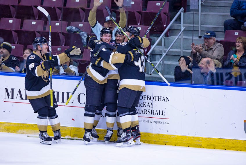 Brady Ferguson is congratulated by defencemen James Melindy (43) and Evan Neugold (8) as Aaron Luchuk prepares to join the celebration after Ferguson scored the game-winning goal with 39 seconds left in the third period to give the Growlers a 4-3 victory over the Toledo Walleye at Mile One Centre Friday night. — Newfoundland Growlers photo/Jeff Parsons