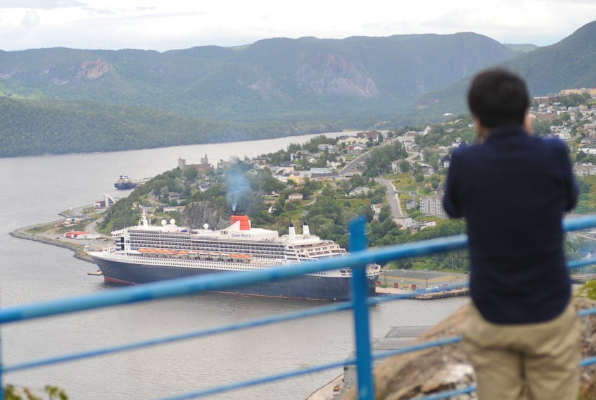 Tsubasa Nukui of Japan photographs the Queen Mary 2 from high above Crow Hill. He arrived on the ship in Corner Brook Thursday.