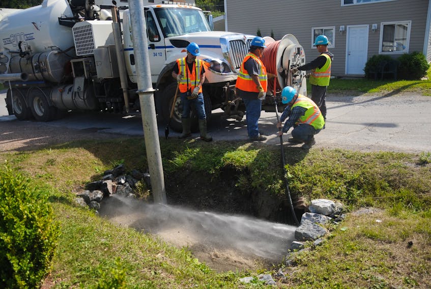 A City of Corner Brook crew cleans out a trio of culverts clogged with rock and dirt on St. Aiden’s Road Friday in advance of the arrival of the remnants of Hurricane Dorian this weekend. The debris was cleared out by pressurized water being sent through the pipes, then sucked up by the vacuum truck.