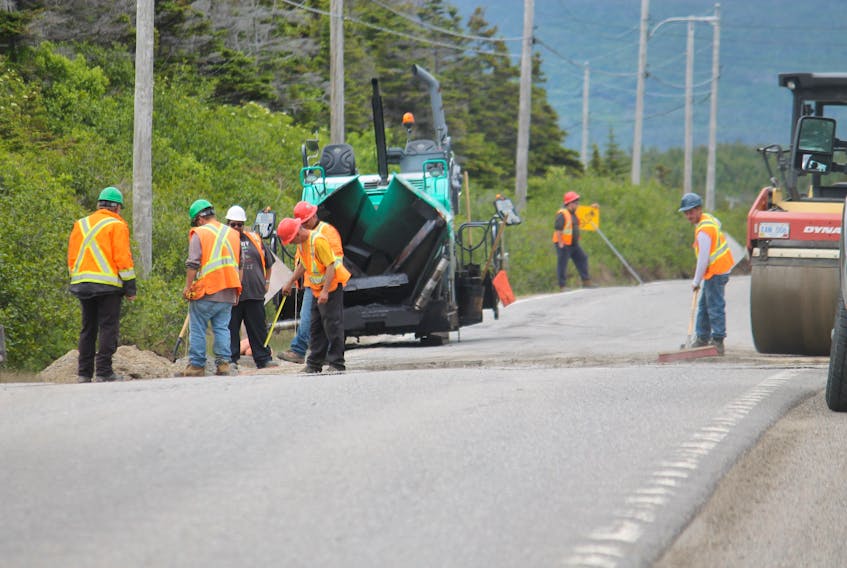 Workers were busy last week paving over cutout sections of roadway in Kippens, Port au Port East and on the Port au Port Peninsula where older culverts had been replaced. Here, they are seen working in a spot near Felix Cove on Route 460. FRANK GALE/ THE WESTERN STAR