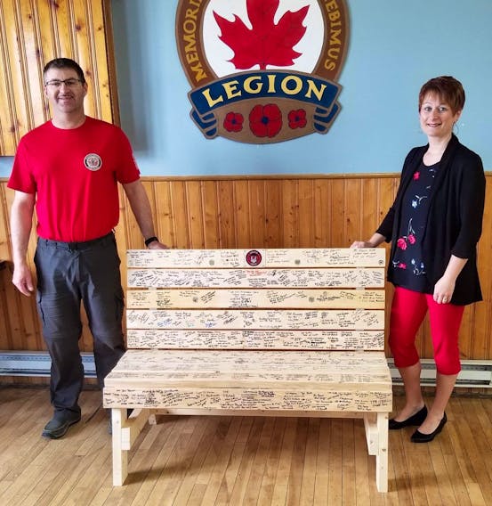 Colin and Cindy Seymour with the memorial bench at the Royal Canadian Legion in Port aux Basques, N.L.