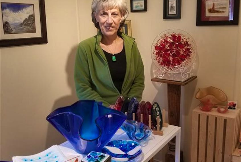 Marlene McRoberts shows off some of her fused glass art at the Katie-Lew Art Studio and Gallery, which she operates with her husband Steve in Rose Blanche. JULIA GOODYEAR