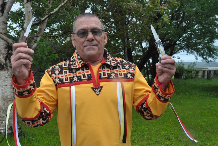 Danny White, a native of Shallop Cove in St. George’s now living in Peterborough, Ont., proudly displays the tools of the trade in traditional Mi’kmaq basket weaving – two pocketknives. FRANK GALE/ THE WESTERN STAR