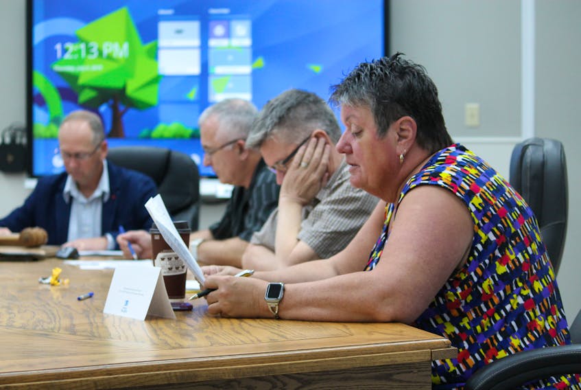 While Deputy Mayor Susan Fowlow reads out a permit item, other members of council from left: Mayor Tom Rose, Coun. Mark Felix and Coun. Mike Tobin listen in at the town council of Stephenville’s regular general meeting on Thursday.