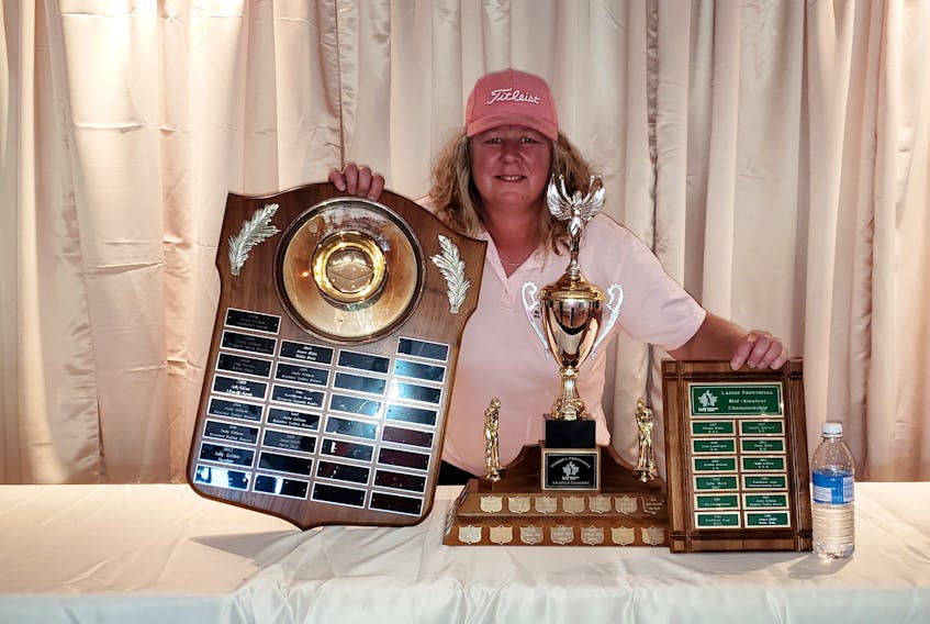 Kathleen Jean displays the winning hardware after capturing the triple crown at the Provincial Women’s Amateur Golf Championships. CONTRIBUTED PHOTO