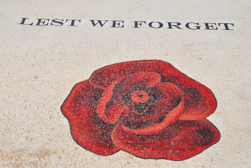 The wording “Lest We Forget” and a large poppy have been etched into the cement walk at Veterans’ Memorial Square in Cape St. George. FRANK GALE/ THE WESTERN STAR