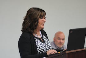 Outgoing Corner Brook Minor Hockey president Jackie Simms delivers her report at the organization’s annual general meeting Wednesday evening, while association vice-president Matt Rogers listens in the background.