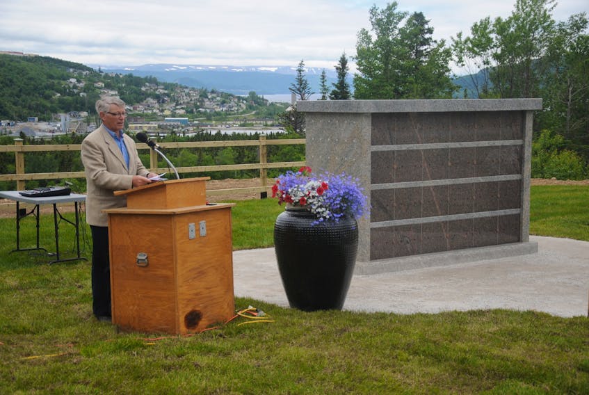 Lloyd Walters, president of the Mount Patricia Cemetery Association, emcees the unveiling and dedication of the cemetery’s first columbarium Thursday. With the rising popularity of cremation, the association expects to be erecting new monuments for holding urns of cremated remains every few years from now on.