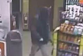 The Royal Newfoundland Constabulary are looking for the person seen in this surveillance video footage in connection with an armed robbery at a Corner Brook service station on Sunday night.