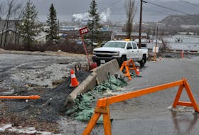 Water flows down over Charles Street in Corner Brook Wednesday. Heavy rains put pressure on the storm sewer system in the area, causing the water to overflow over the street.
