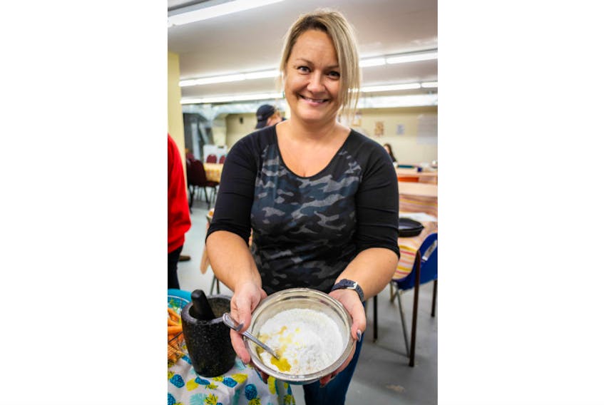 Lori Fillatre makes luskinikn, the Mi'kmaq version of the familiar bannock at a recent tourism experience event in St. George’s. CONTRIBUTED BY JONATHAN MEYERS