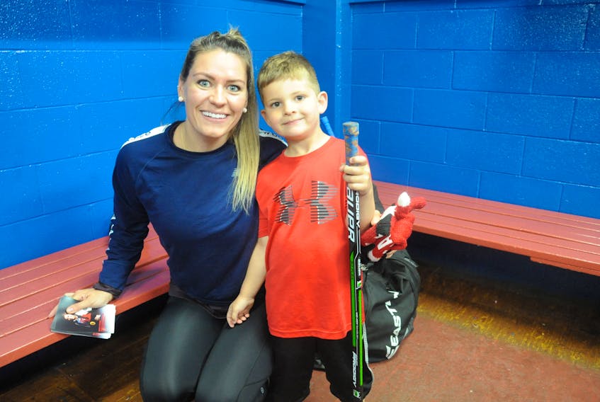 Olympic women’s hockey gold and silver medallist Natalie Spooner poses for a photo with minor hockey player John Sigurdsson during her recent visit with PlayPro Hockey Camp in Corner Brook.