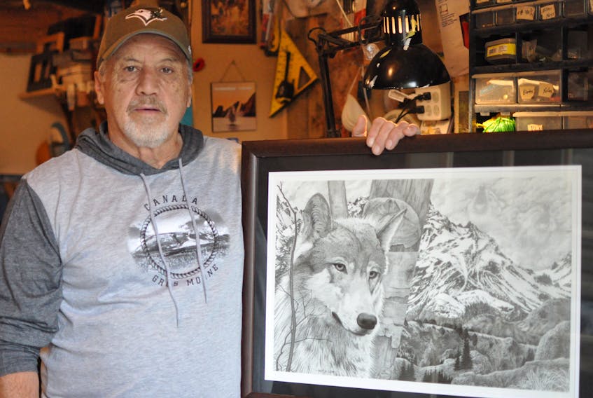 Nathan Pinsent displays one of his pencil drawings of a wolf. The Corner Brook man spent 56 years living away before coming home last year.