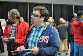 Sheldon Hatcher of Port au Port is seen chatting with a company representative from Marco Services Limited at a job fair for the construction of the new regional hospital held at the Corner Brook civic centre Tuesday.