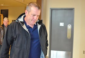 Former Corner Brook RNC officer Sean Kelly enters a provincial courtroom on Monday for the start his trial on a charge of making indecent phone calls.