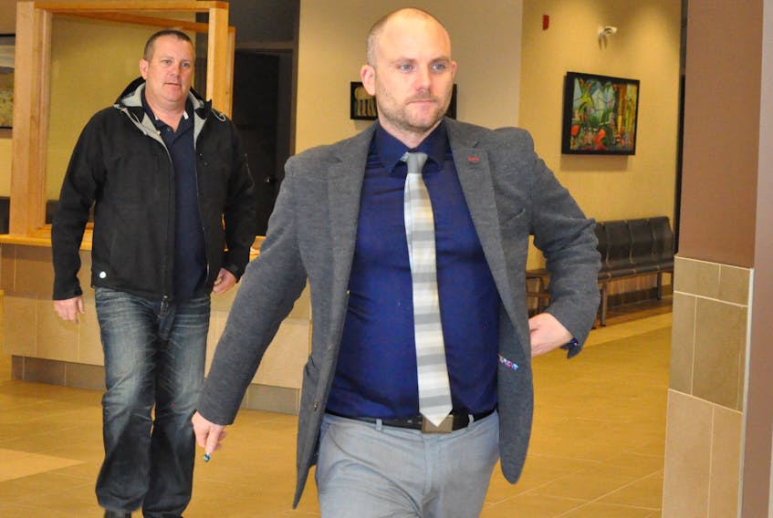 Former Corner Brook Royal Newfoundland Constabulary officer Sean Kelly, left, follows his lawyer Rob Ash into provincial court Monday. - Diane Crocker/The Western Star