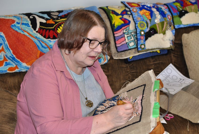 Corner Brook artist Jackie Alcock works on a rug hooking of a cat. Alcock has been named a finalist in the 2019/2020 Salt Spring National Art Prize competition. She submitted a rug to the contest that is part of her forget-me-not project.
