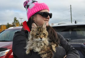 Angela Street holds her cat, Kyou, during a rally in Corner Brook Wednesday, calling for justice in the recent death of a cat in Port aux Basques and for changes in animal cruelty laws.