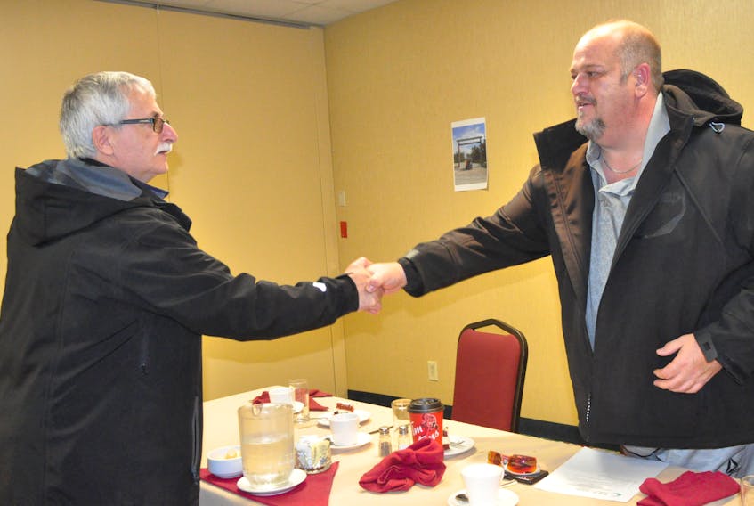 David Callahan, right, president of Back Home Medical Cannabis Corporation, gets a handshake from Bob Byrnes, an executive member of the Bay St. George Chamber of Commerce, after Callahan addressed the chamber's Small Business Week luncheon meeting Oct. 21. FRANK GALE/THE WESTERN STAR