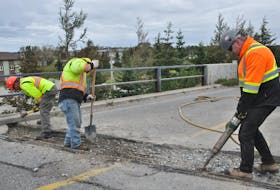 Workers with EFCO Enterprises in Stephenville were busy earlier this month, carrying out emergency repairs to the deck of the overpass on Minnesota Drive where it crosses Carolina Avenue. They include, from left, Gilbert Curnew, Kenny Gaudet and Grant Curnew. FRANK GALE/THE WESTERN STAR