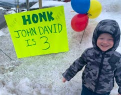 John David Lavallee is seen by his birthday sign outside his Massey Drive home on Wednesday.