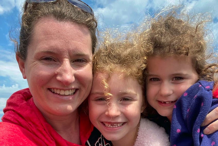 Shanda Slipp of Corner Brook and her daughters, Alice Brazil, centre, and Evie Brazil were all smiles when they reunited in New Brunswick on June 5.