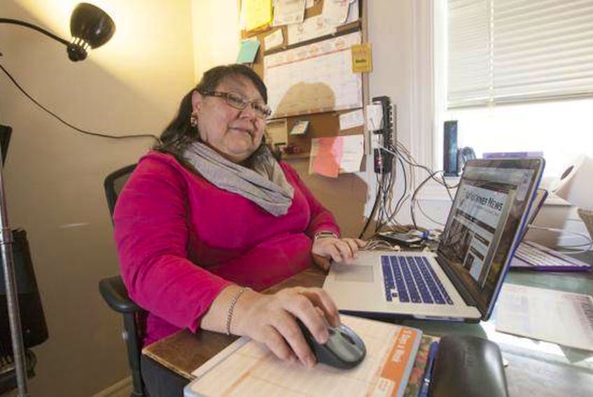 Maureen Googoo of Ku'ku'kwes News in her ‘home office,’ the kitchen table of her home. Googoo runs the news website dedicated to the aboriginal stories from Atlantic Canada.