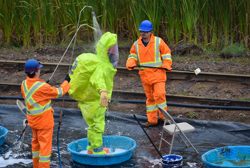 The protective suits were washed with soap and water before members removed them as they would be in a real situation during a mock training exercise at Northern Pulp on Saturday, Sept. 29.