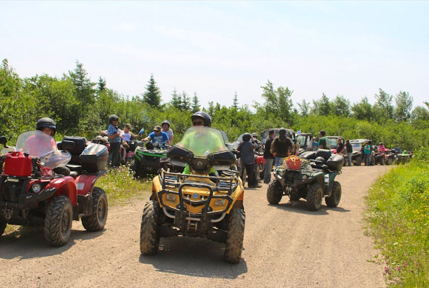 Participants on their ATVs for the ride. - Contributed
