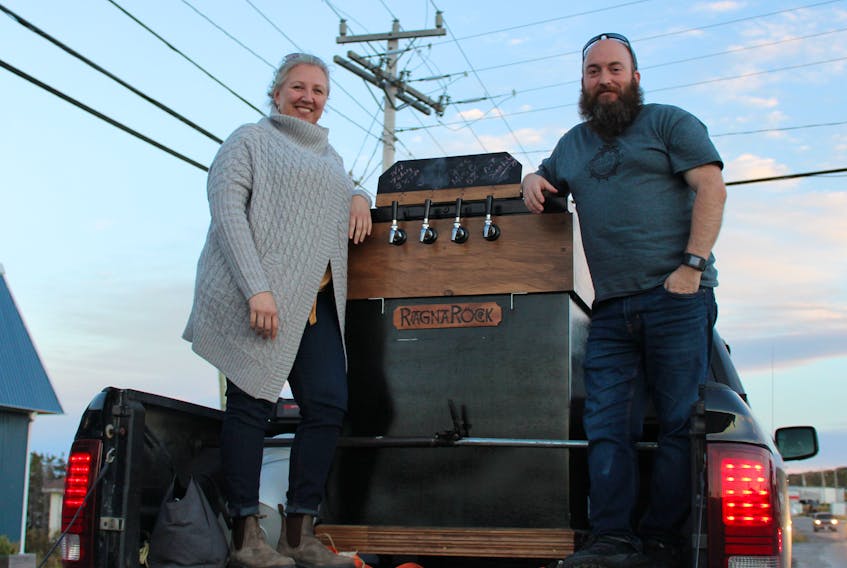 Jennifer and Brad Simms, two co-founders and directors of RagnaRock Northern Brewing Company pose with the tap bank for their new brewpub that was approved by the Newfoundland government last week. Not pictured, co-founder and director Lauren Smithson.