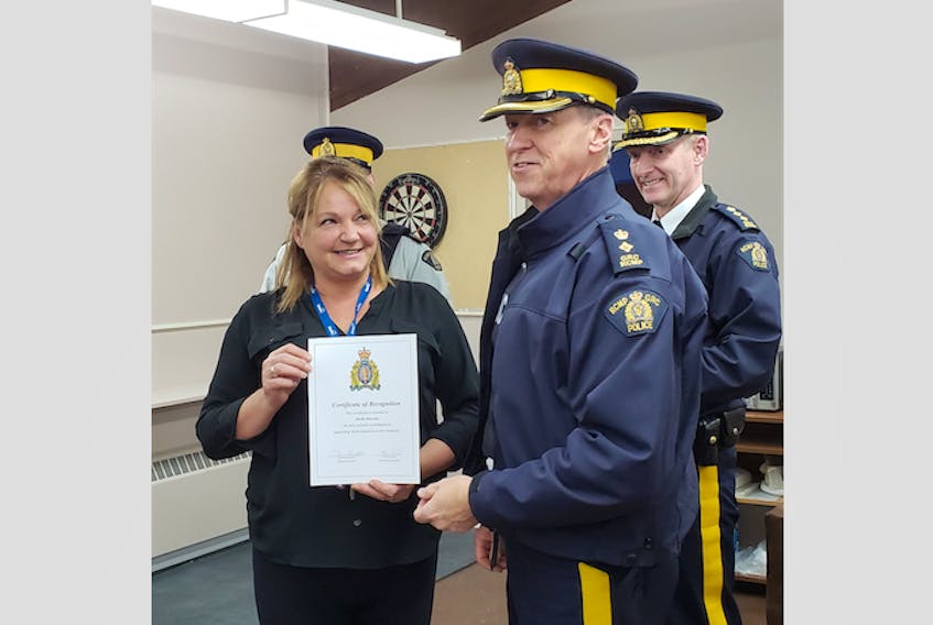 RCMP Supt. David Cook presented Sheila Doucette, youth regional coordinator at the Port Saunders Youth Centre, with a certificate of recognition.