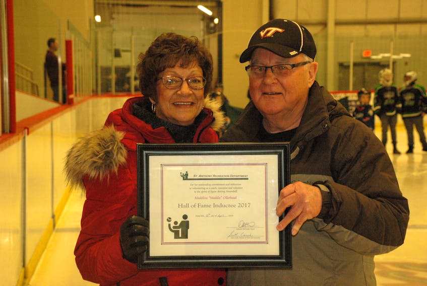 St. Anthony Recreational Department Hall of Fame 2001 inductee Eric Boyd (right) presents a certificate to Madeline Ollerhead.