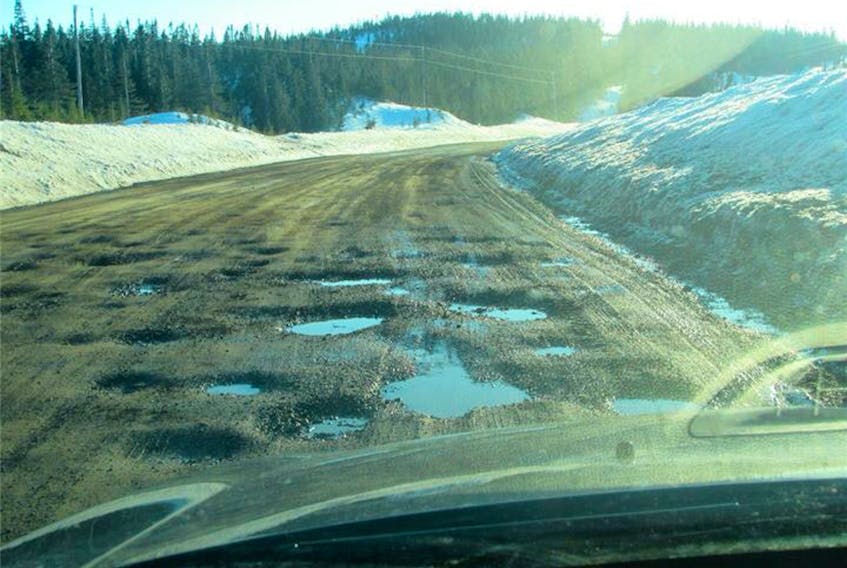 Photos show the Conche highway, Route 434, peppered with potholes.