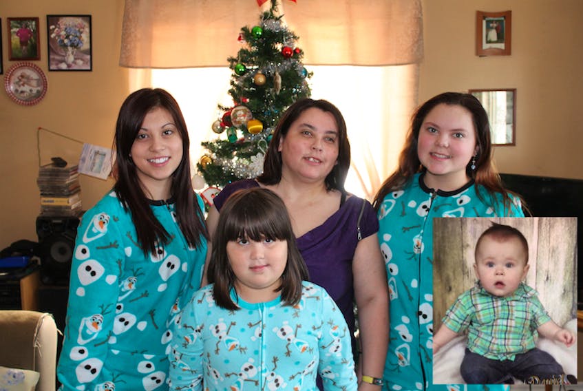 Wavey Ward is fighting for financial assistance for herself and her family. Ward, center, and three of her children, from left, Selina, Nicole and Natalie are pictured during the Christmas season. Nicole and Natalie are school aged and live with their mother, along with her grandson Daniel (inset ). - Submitted photos
