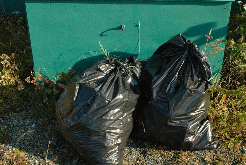 Garbage bags beside a bin. Stephen Roberts/The Northern Pen photo