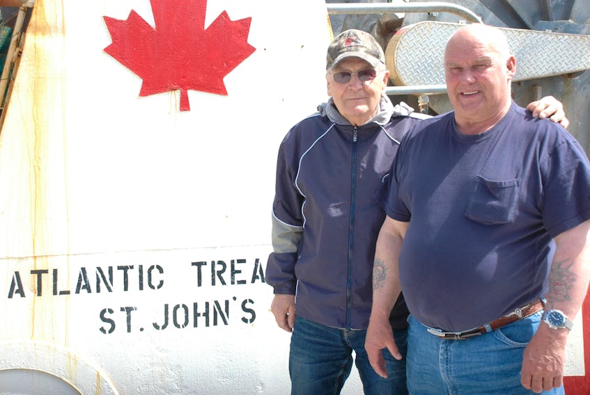 Former mining colleagues, Ben Waldner (left) and Glenn Penney reunited in St. Anthony this past week after not having seen each other for nearly 50 years. They're pictured here beside the Newfoundland Treasure, a boat formerly owned by Penney.