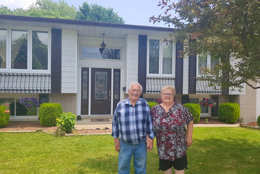 Garth and Donna Earle standing in front of the Kingsville, Ontario home they share with their son, daughter-in-law and, soon, their granddaughter. -
 Submitted photo