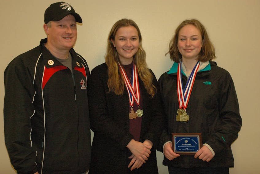 On Saturday, Nov. 10, St. Anthony Parks and Recreation director Scott Coish presented St. Anthony Dolphins swimmers Chole Clarke (centre) and Angela Cronhelm (right) their medals from the Gander provincials swim meet they competed in this past summer. For the second consecutive year, Cronhelm took home the Top Female Achiever award for winning the most individual points in the 17-18 age group. Clarke was presented with her bronze medal for the girls 17-18 breaststroke.