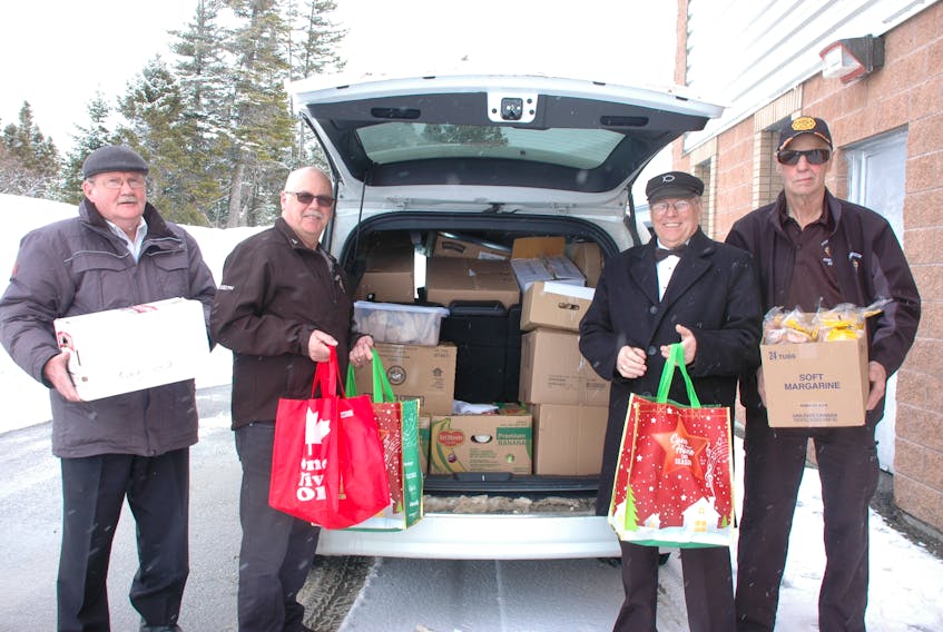 Members of the Knights of Columbus from Corner Brook, including, from left, past Grand Knight Joe Byrne, District Deputy Keith Kean, past Faithful Navigator John Carroll and Al Whalen unload their van outside the cafeteria of Cloud River Academy, delivering goods to the boys and girls of Roddickton-Bide Arm. Not available for the photo were Grand Knight Mike Connolly and State Treasurer Pat Gambin.