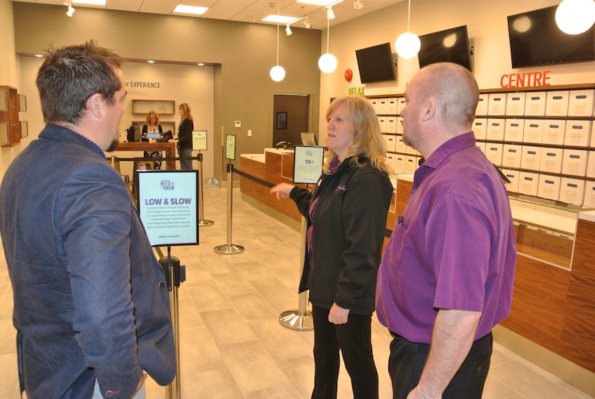 Monique Zollner, manager of the Amherst Superstore NSLC, talks to regional manager Chris Mitton (left) and store assistant manager and cannabis section manager John Estabrooks about the cannabis section in advance of the store’s opening