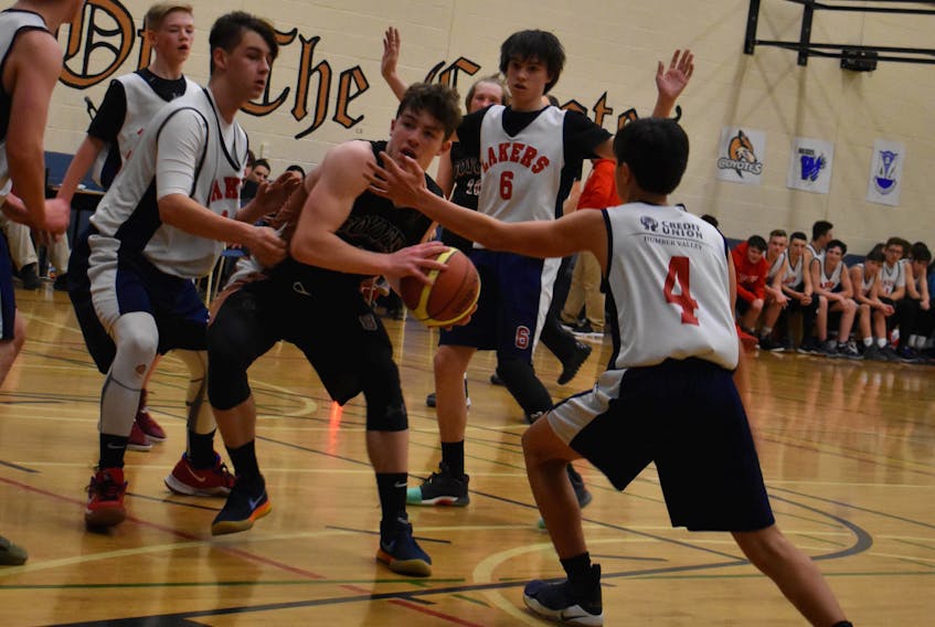 Andrew Small of Copper Ridge Academy takes the ball through a swarm of Elwood defenders during a round-robin game in the Baie Verte Invitational boys basketball tournament.