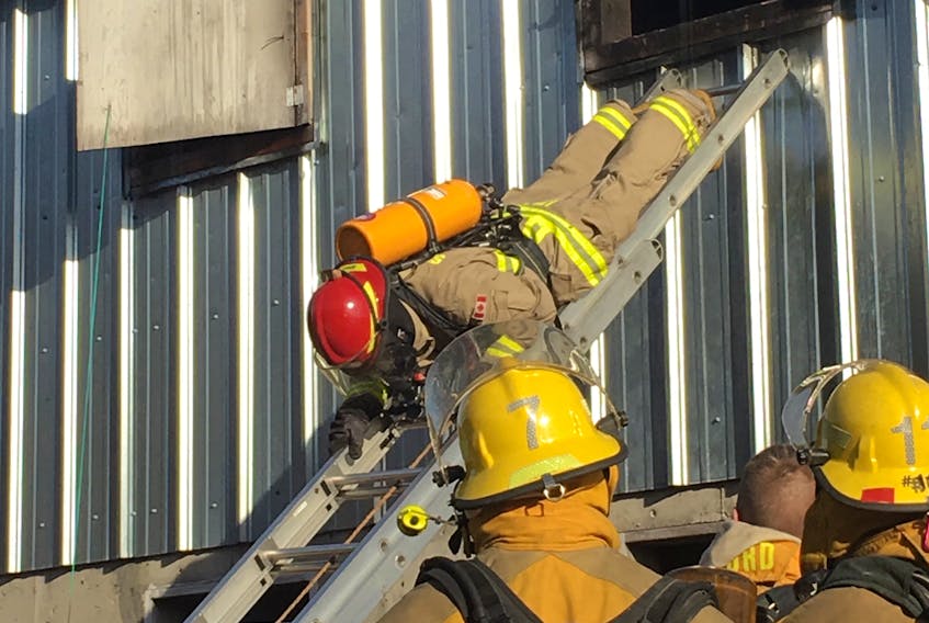 Firefighters train for escapes from burning buildings during regional training exercises in Springdale recently.
