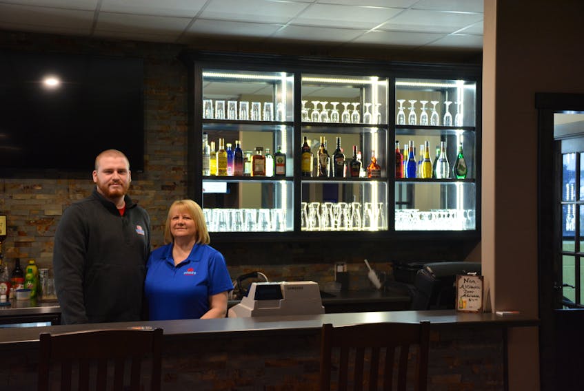 Co-owners Keith Noble and his mother Caroline Noble stand behind the bar at Springdale Inn and Suites. They acquired the hotel in October and have big plans for the business.