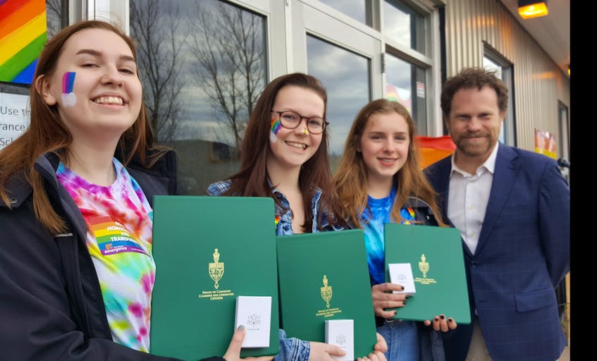 The leaders of the Indian River High Gender Sexuality Alliance, from left, Claudia Lilly, Megan Paddock and Maria Lawlor were presented Canada 150 Sesquicentennial pins from Coast of Bays-Central-Notre Dame MP Scott Simms.
